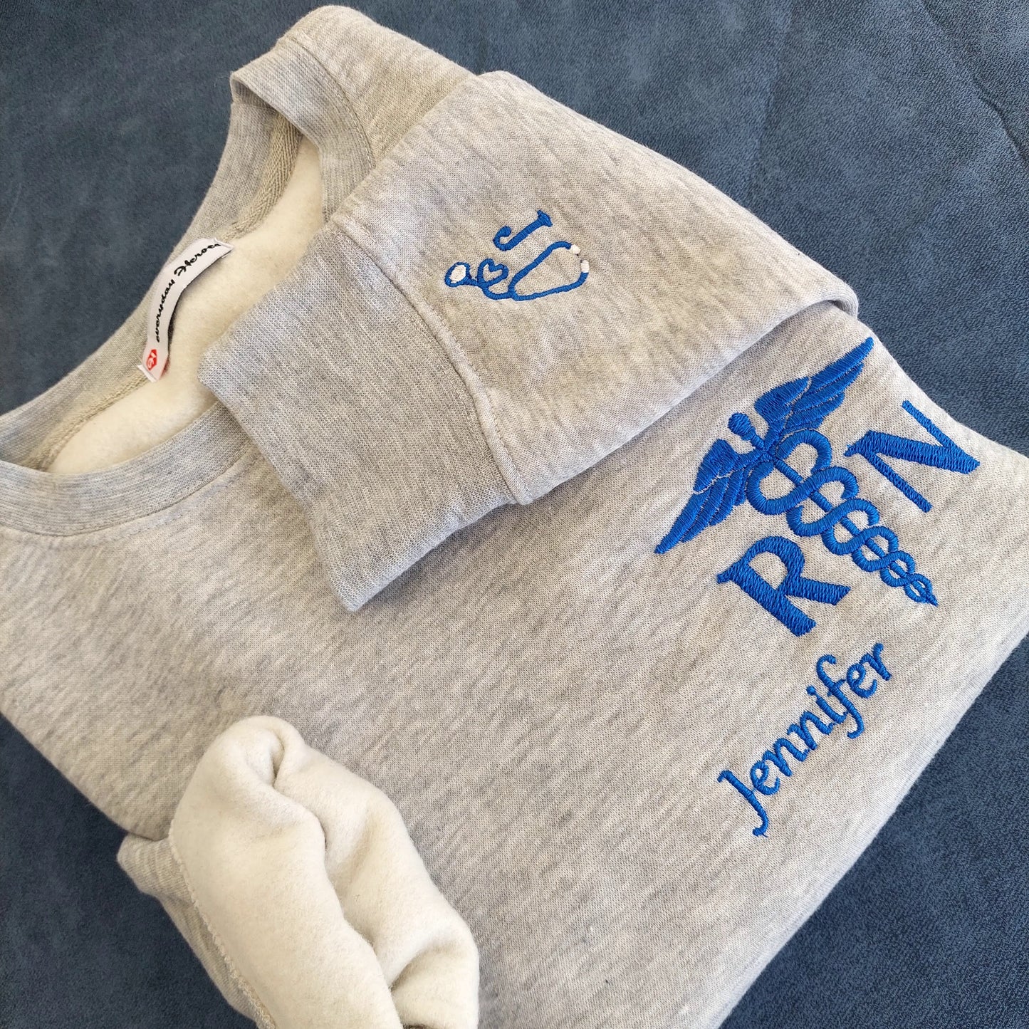 Sample shown with Royal Blue thread for name and caduceus & credentials on grey melange sweatshirt*