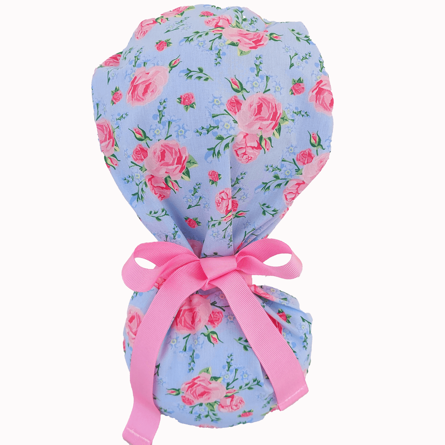 a mannequin head wearing a scrub cap ponytail for nurses ,with pink roses and a pink ribbon i tie