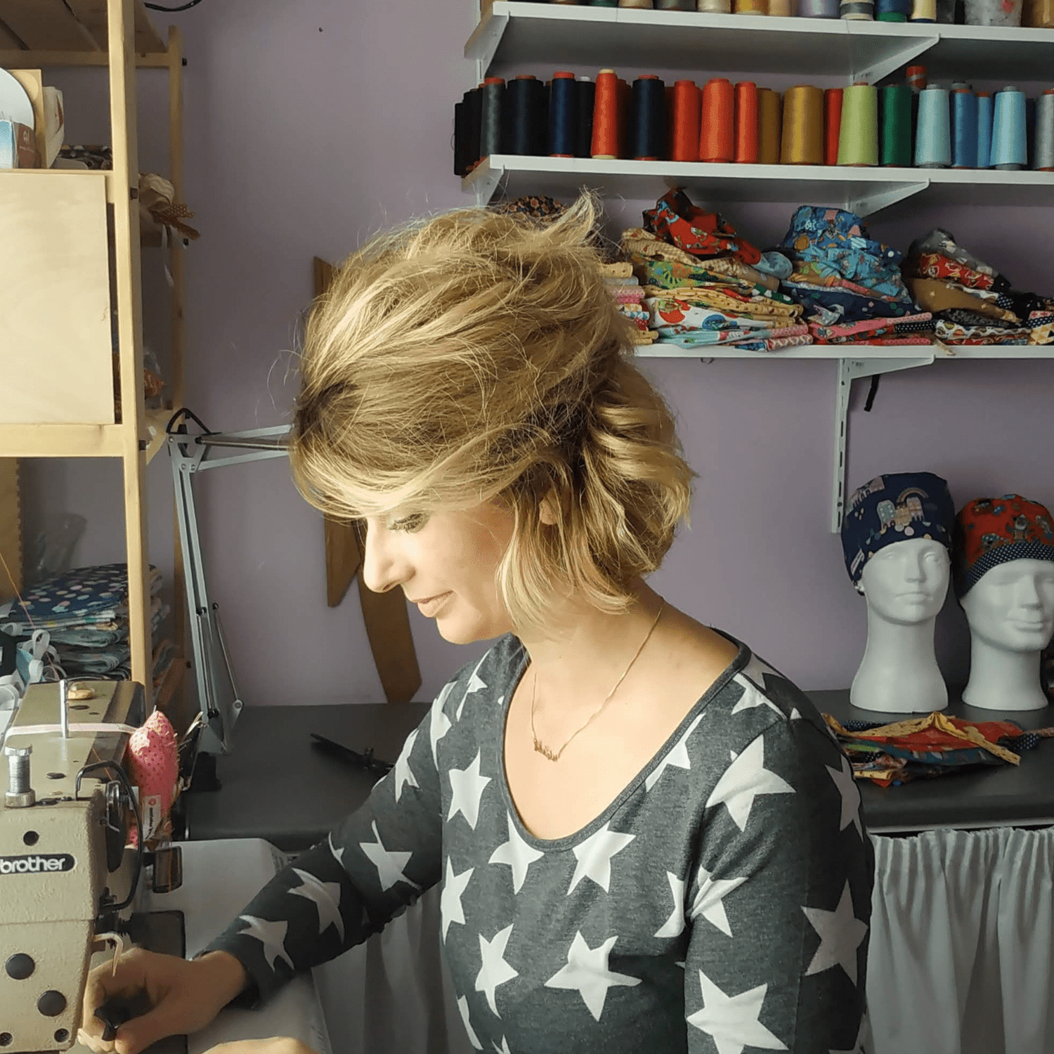 Swoing the shop owner sewing and making scrub caps on her small sewing studio