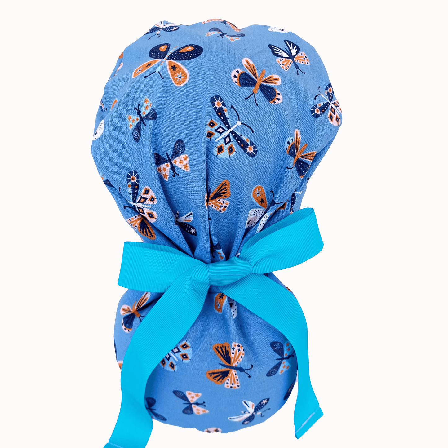 Scrub Cap For Nurses In a mannequin head ,the surgical cap have vibrant blue color and butterflies on it !