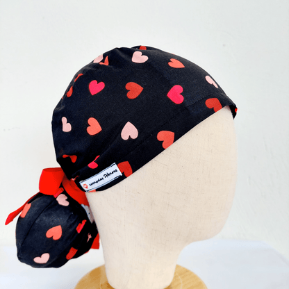a doll head wearing scrub cap with a ponytail  pounce , red and pink hearts with red ribbons