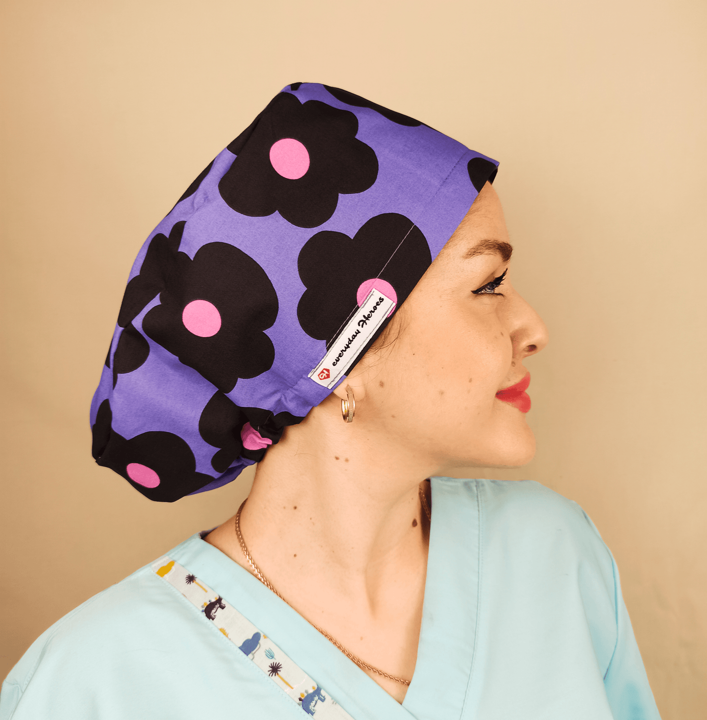 purple scrub cap with black and pink daisies