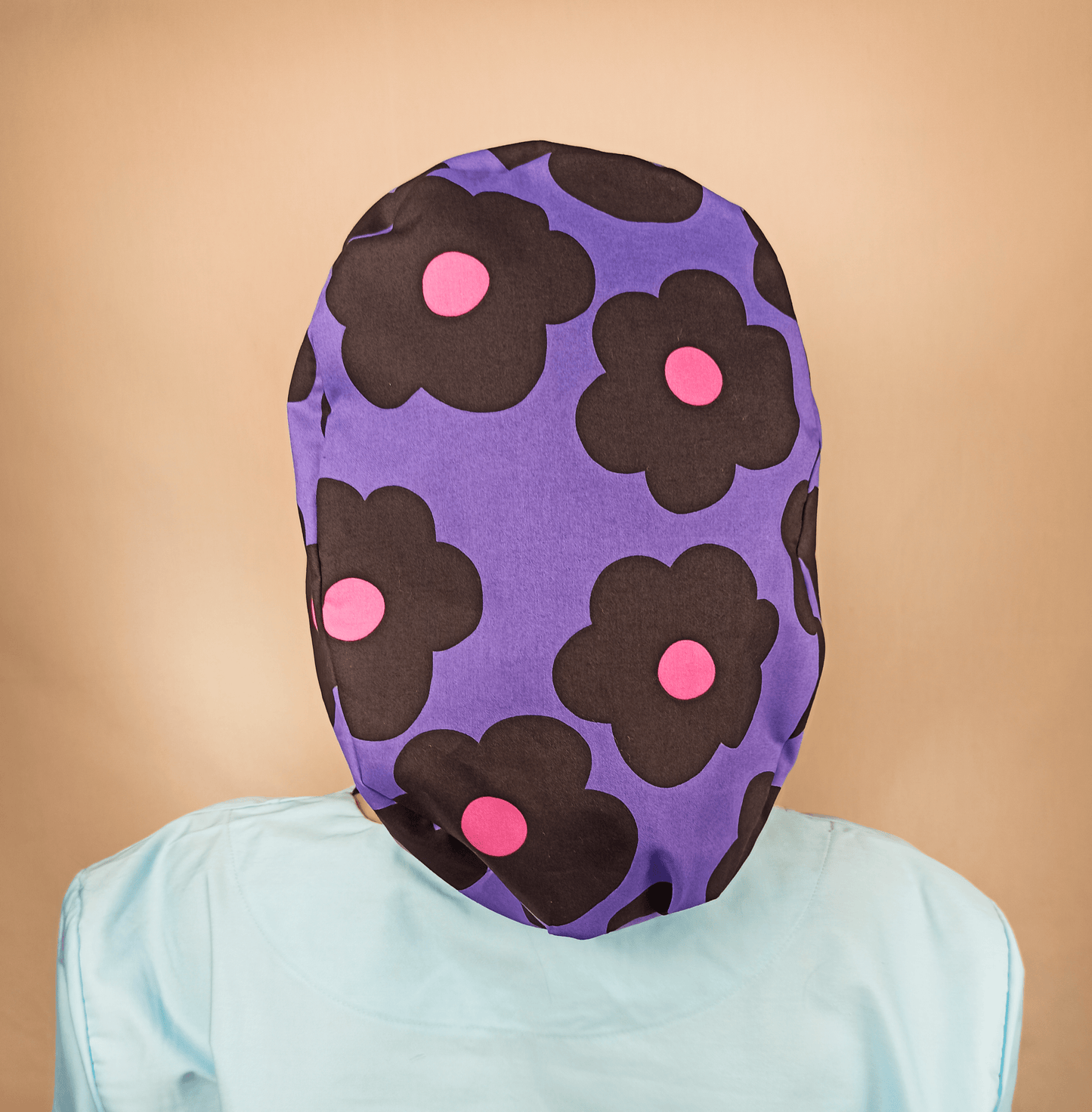 purple scrub cap with black and pink daisies