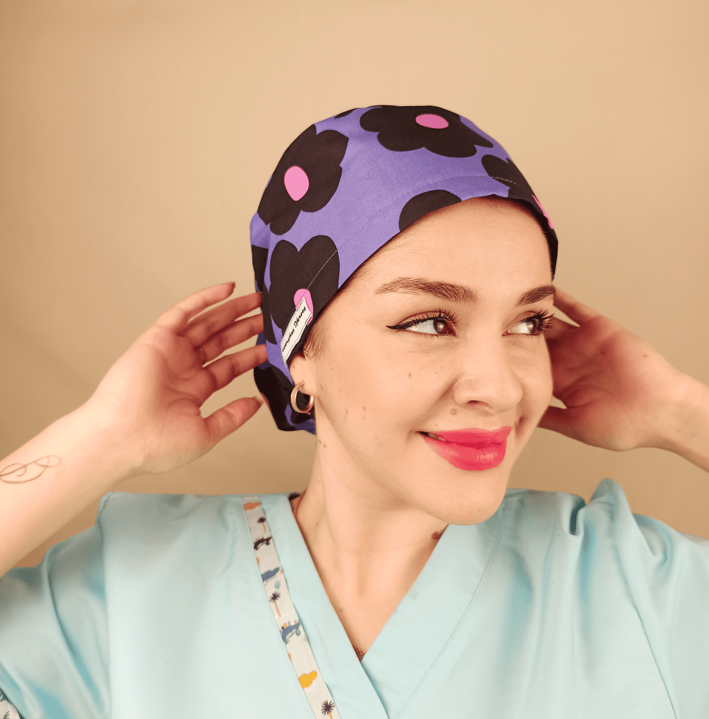 purple scrub cap with black and pink daisies