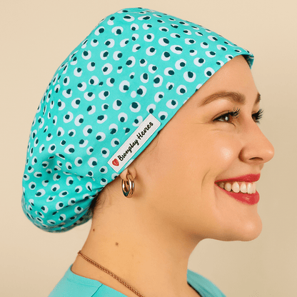 a woman wering a scrub hat that fits on her head , the cotton print i blue leopard . the style is euro scrub hat 
